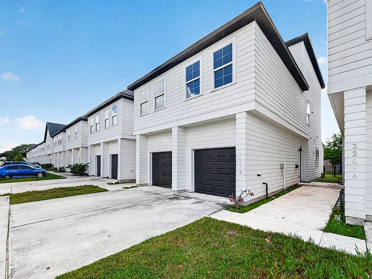 Modern three-story home with an attached one-car garage.