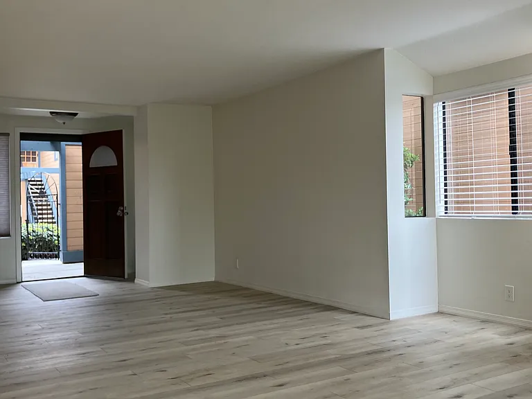 Living area and entry. Security screen door allows for natural airflow. Ocean breeze throughout.