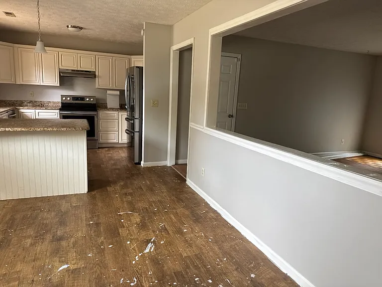 Updated kitchen with stainless steel appliances and granite countertops. Dining room off kitchen. Wall beside Kitchen allows clear view to large living room. New floors to be installed by 10 July.