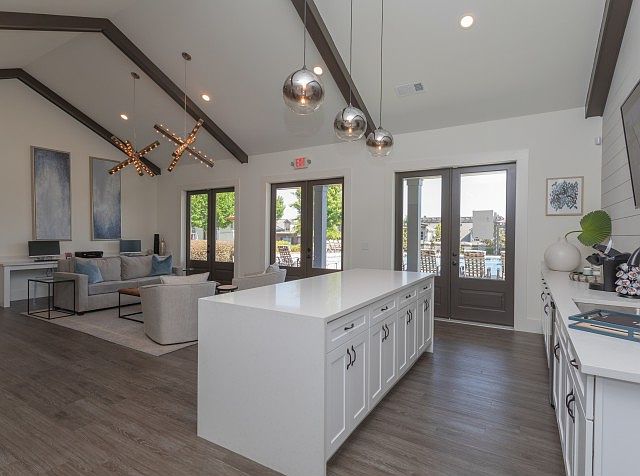 Clubhouse with large kitchen island, pendant lights, and open lounge area