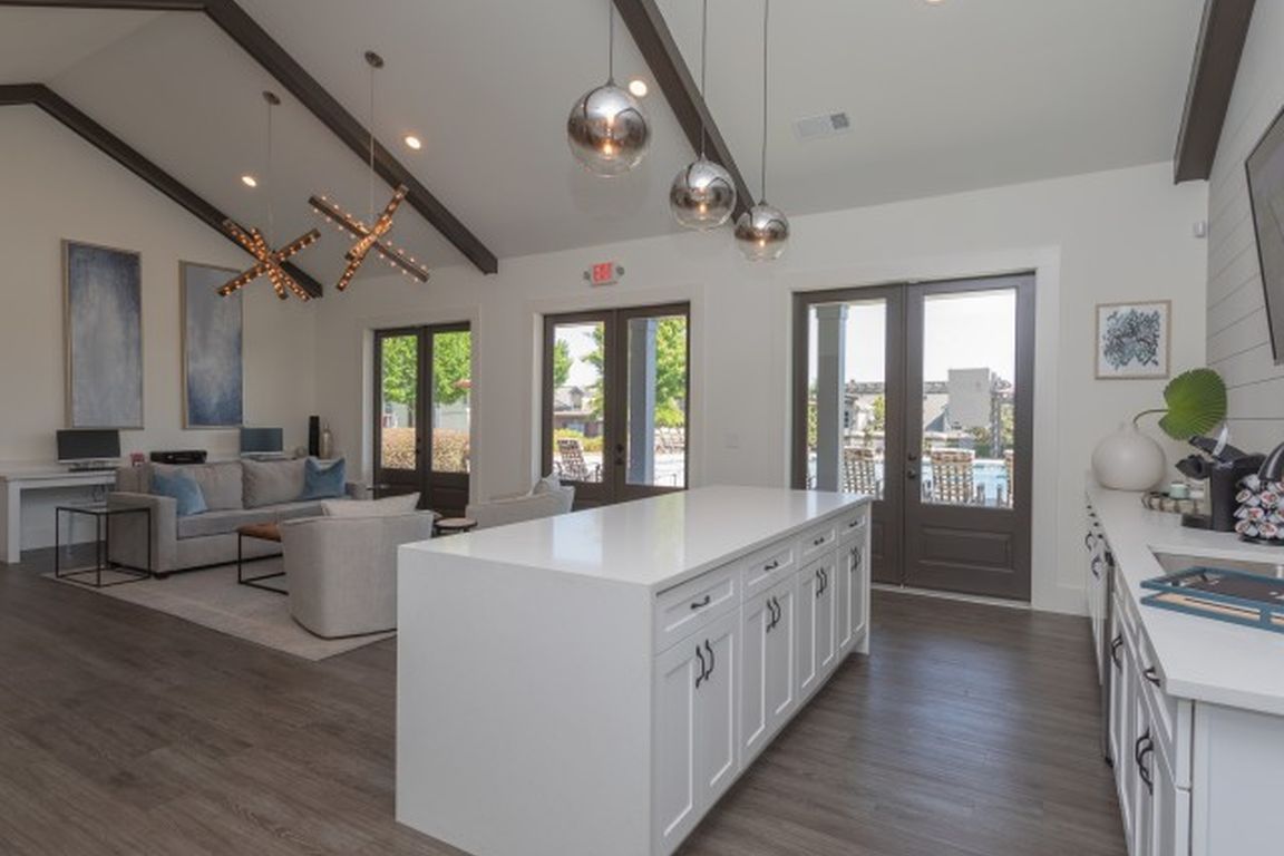 Clubhouse with large kitchen island, pendant lights, and open lounge area