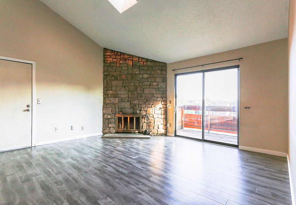 Beautiful hardwood laminate floors, fireplace, vaulted ceili