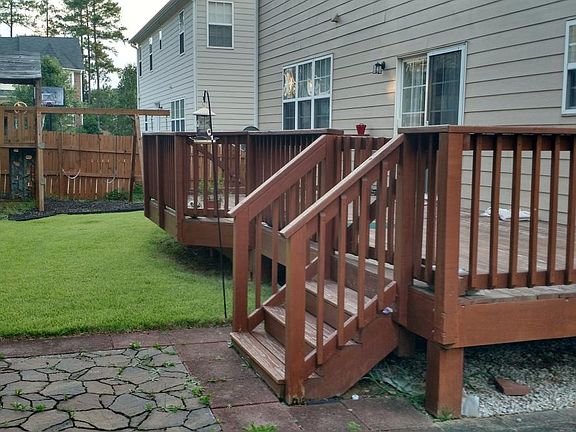 Fenced backyard with huge deck and stone patio