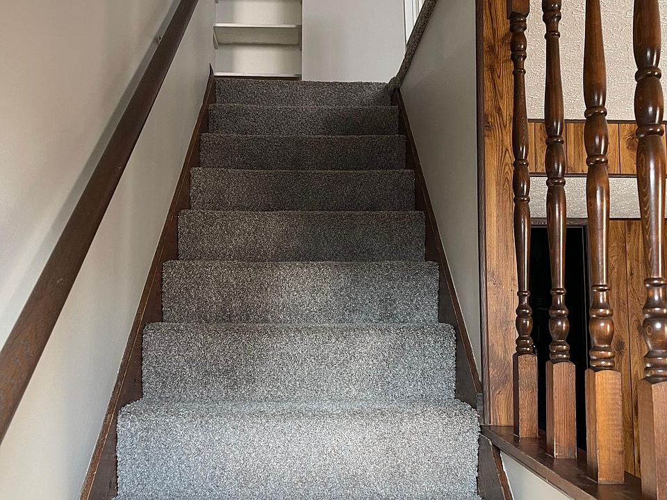 stairs to upstairs living area (kitchen, full bathroom, living room and bedrooms)