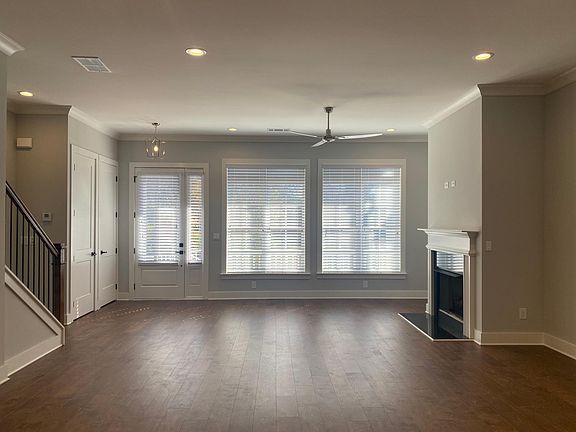 Living room with wall of windows and marble fireplace with gas logs!