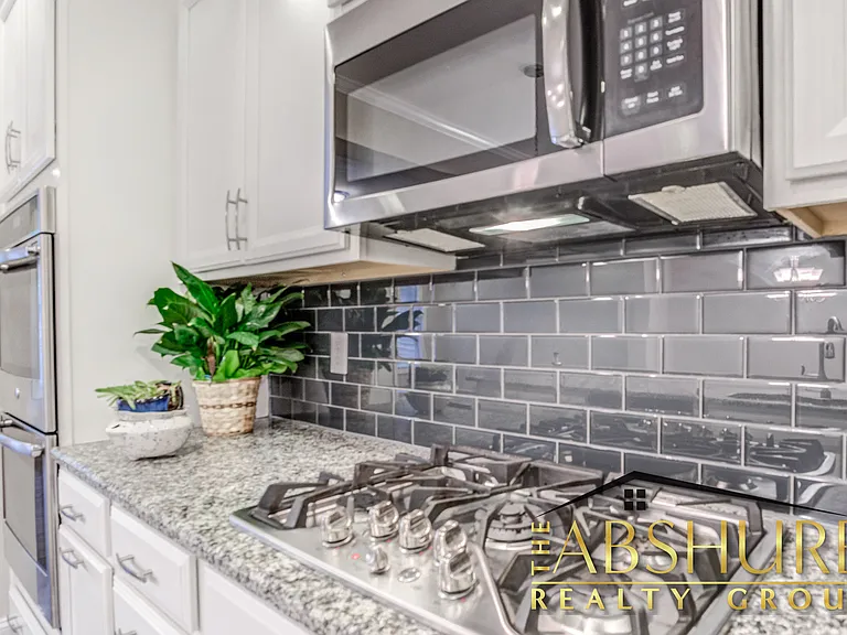 Gourmet gas cooktop, built in microwave, custom tile backsplash