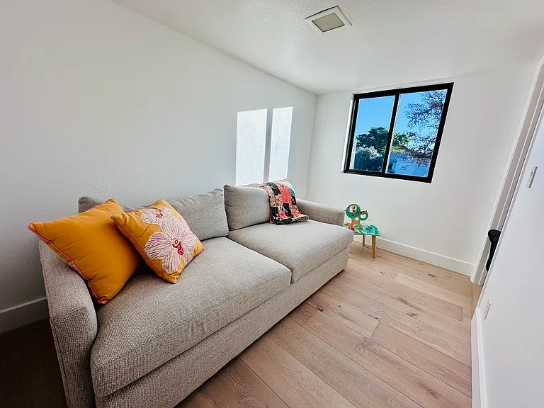 Kid's room featuring a spacious sofa that effortlessly converts into a comfortable bed...