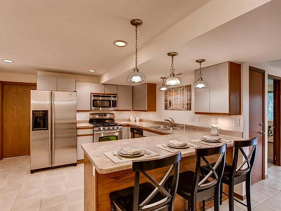 Kitchen. The refrigerator has been changed. The door on the left leads to the half bath and then the laundry room