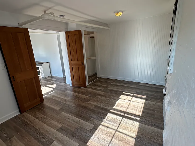 Bedroom with closet and 2 windows. Room can accommodate a queen size bed.