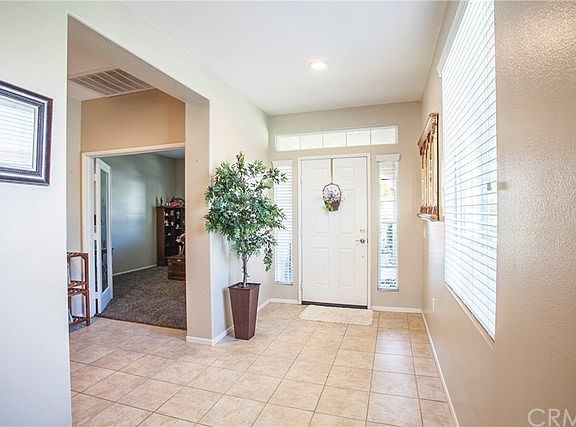 Formal entryway with tile flooring and recessed light