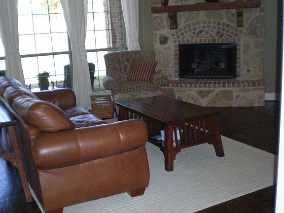 Rock, corner fireplace and wall of windows.