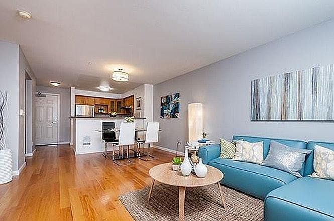 Open concept living-dining-kitchen area with hardwood floors