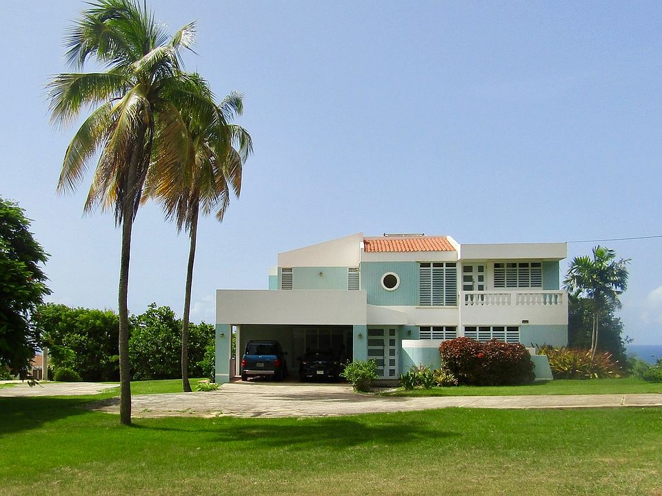 Front View With Double Car-port And Balconies Above/Front Terrace Below