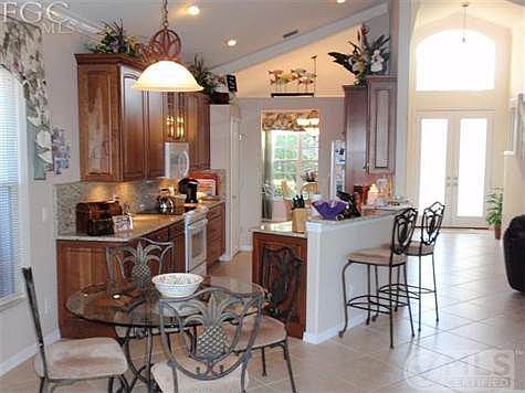 Kitchen and breakfast area, dining room in the back of picture