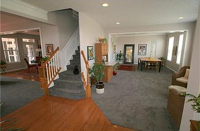 View from the entry into the living and dining rooms.  Note how open the floor plan is with a circular flow around the center stair case.