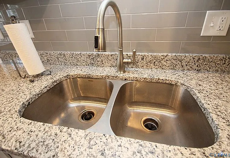 Double sink w/ garbage disposal! Modern subway tile backsplash!