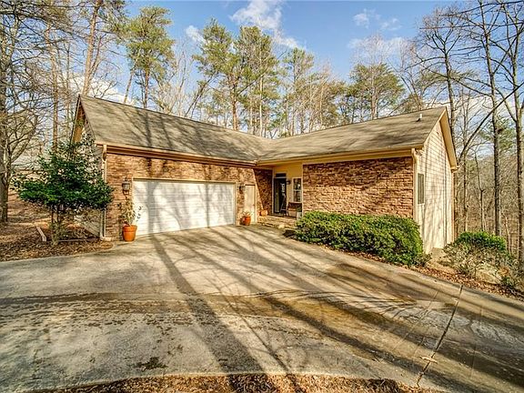 Image 3: Beautiful Stone Accents the Front of the Home