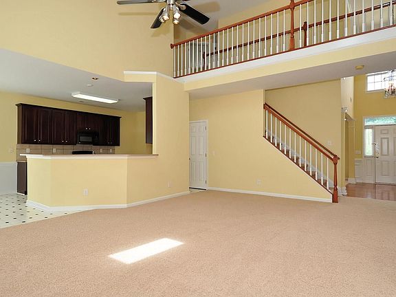 Open great room features new frisee carpet and fresh neutral paint