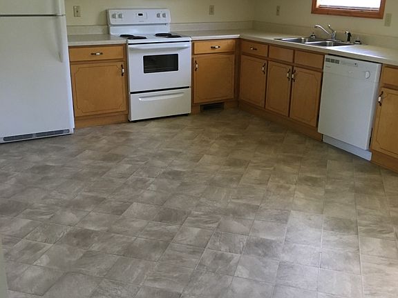 full size eat in kitchen with back door entrance to patio and yard