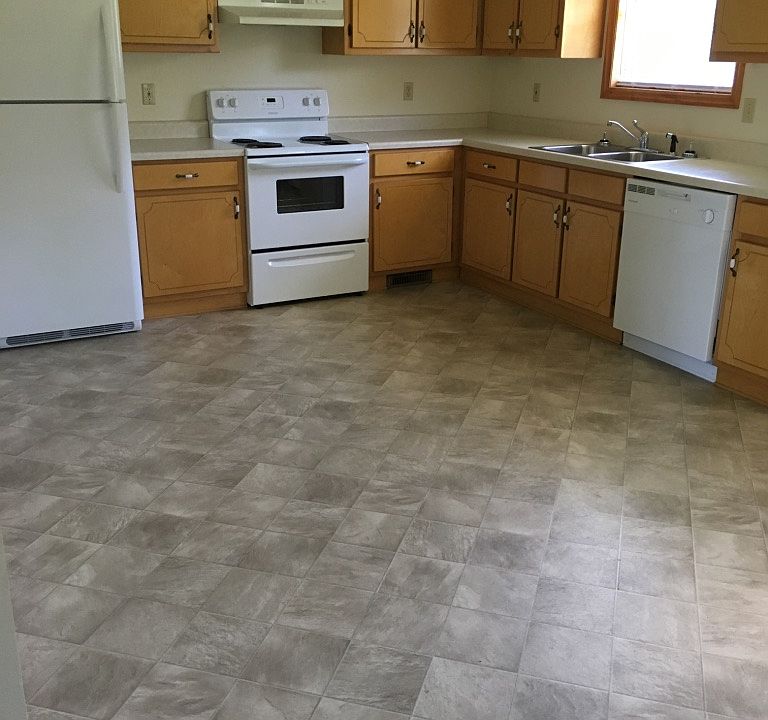 full size eat in kitchen with back door entrance to patio and yard
