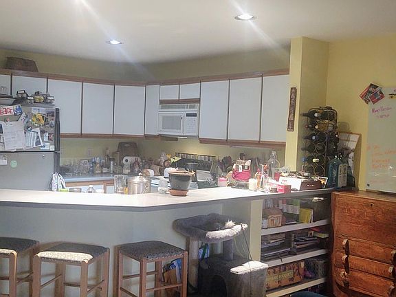 The kitchen is fairly large and open to the living area. The counter makes a great place to eat or work. Large double-door pantry to left.