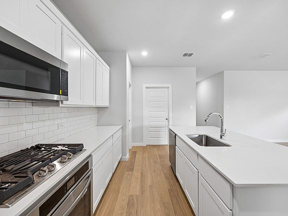 Kitchen in the Oscar home plan by Trophy Signature Homes - REPRESENTATIVE PHOTO