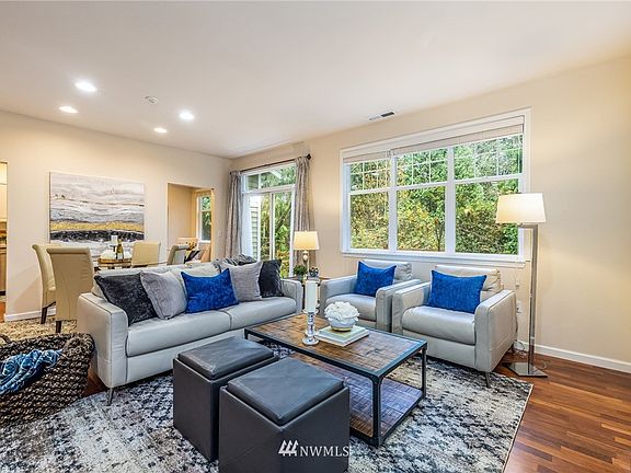 Open great room is filled with light - note privacy provided by mature landscaping