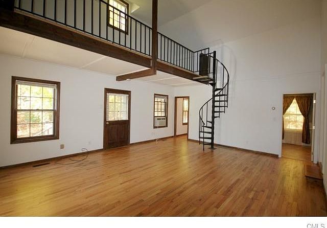 Huge Living Room with Circular Stairs to Loft. Bathroom to R