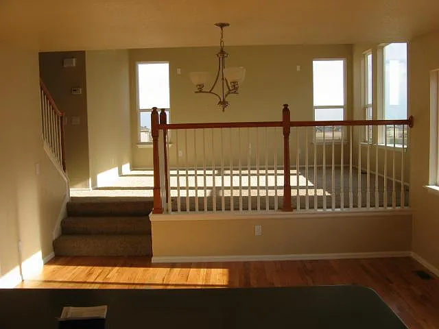View of the living room, as seen from the dining area. The carpeting has now has LVP flooring.