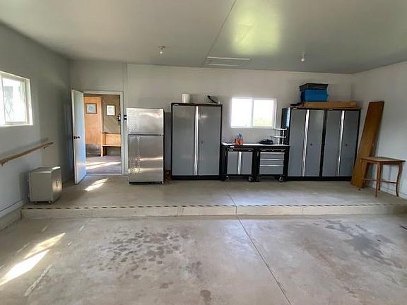 Interior of attached garage.
Cabinets, shelving, and refrigerator / freezer included
