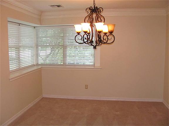 Formal Dining Room also offering dental molding and large window