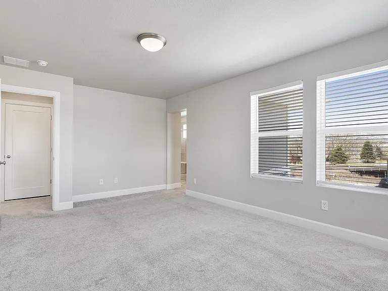 Spacious primary suite with plenty of natural light & mountain views