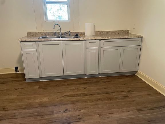 This is an updated photo of the kitchen cabinets and flooring, they have both been refinished.