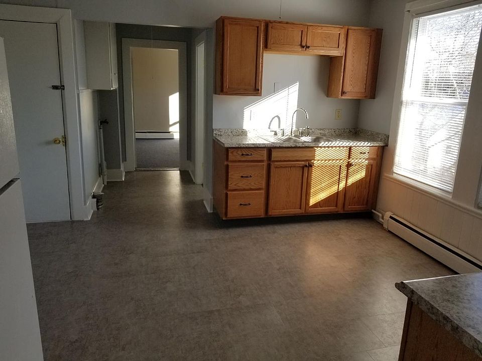 Full renovated kitchen with vinyl plank marble style flooring, new counters, cabinets, sink, and plumbing