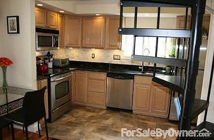 KITCHEN VIEWED FROM LIVING AREA
						:
						All maple cabinets with stainless appliances