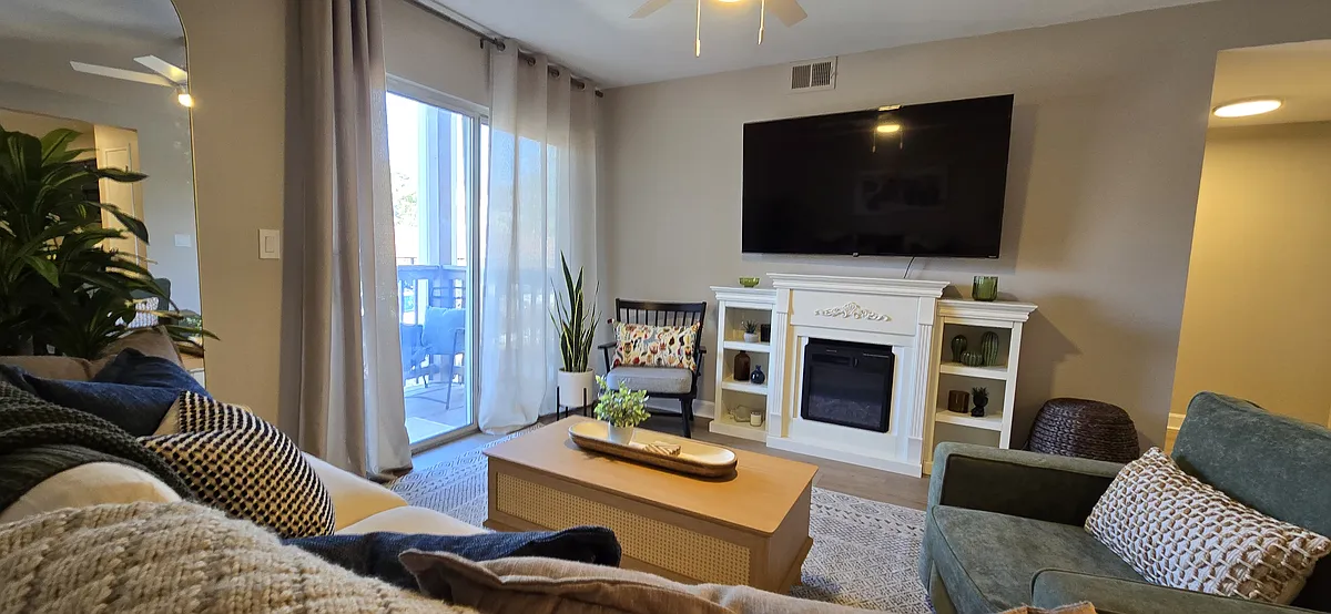 Additional view highlighting the living room's fireplace and connection to the deck. - 757 Ridgeside Dr #G
