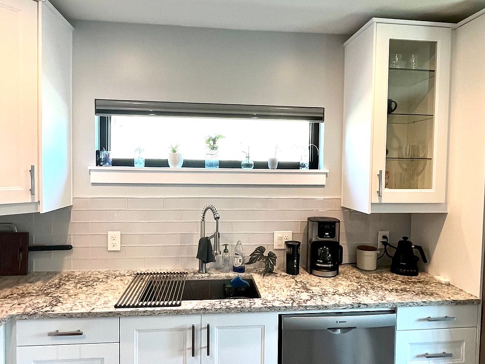 Quartz countertops, in cabinet, and under cabinet lighting for a distinct ambiance.