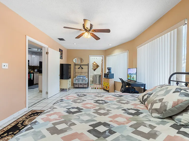 Primary bedroom / mother-in-law suite. Microwave, coffee maker, refrigerator, private bathroom and private entrance.