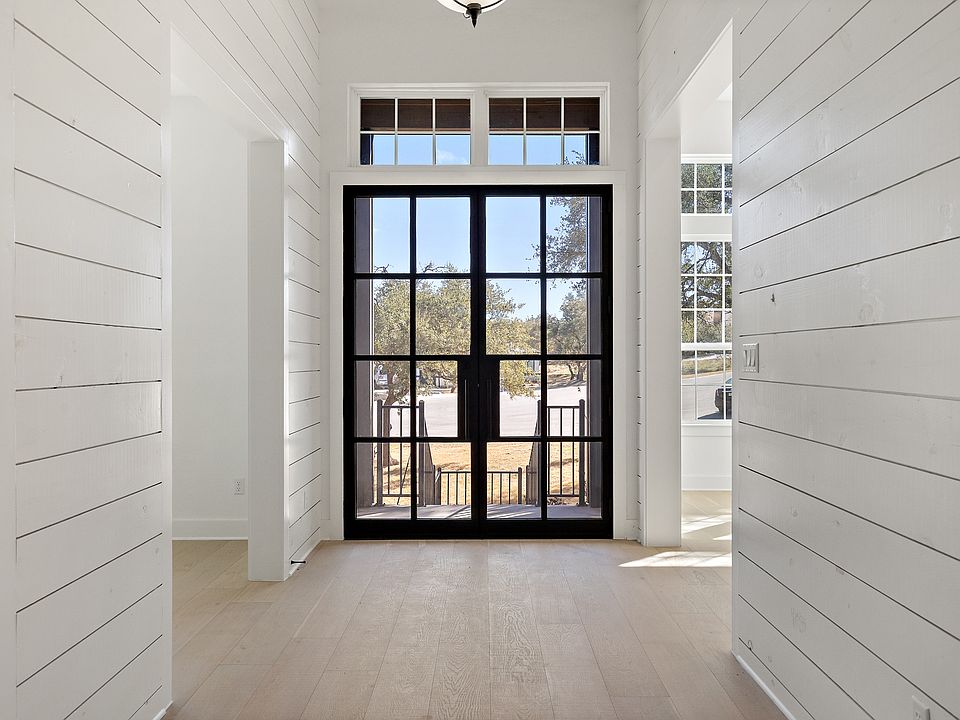 Stunning entry with shiplap and gorgeous paned doors