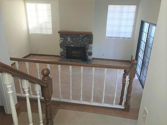 Downstairs with inviting Fireplace leads to private backyard.