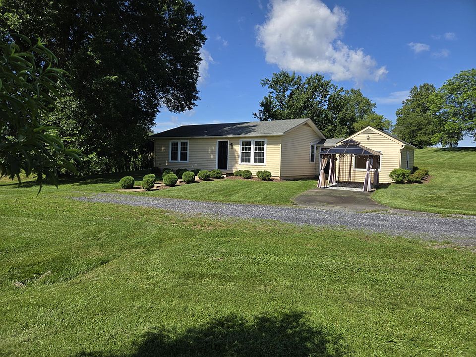 Front of cottage overlooking private pond. Home set privately behind hedges at the edge of this large farm.