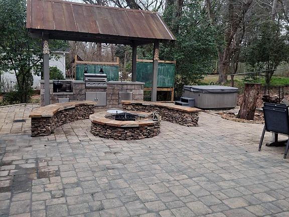 Back living area with fire pit, outdoor sink, natural gas grill and hot tub