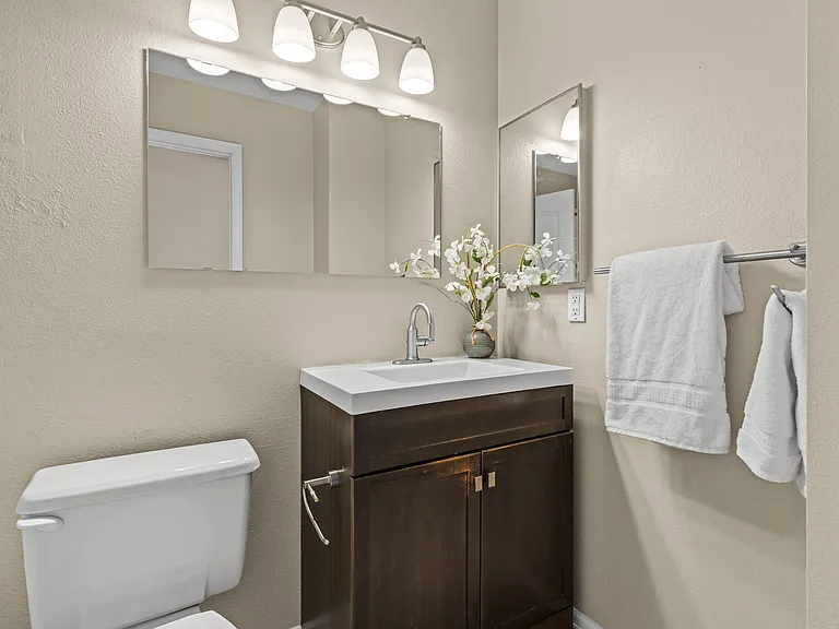 The secondary bathroom offers plenty of storage with under-sink storage, medicine cabinet, and towel rack.