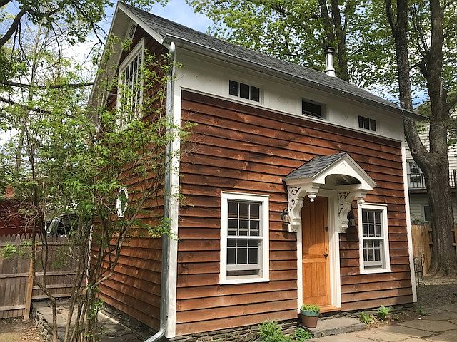 The cottage is tucked away from the street in a secluded rear yard area.