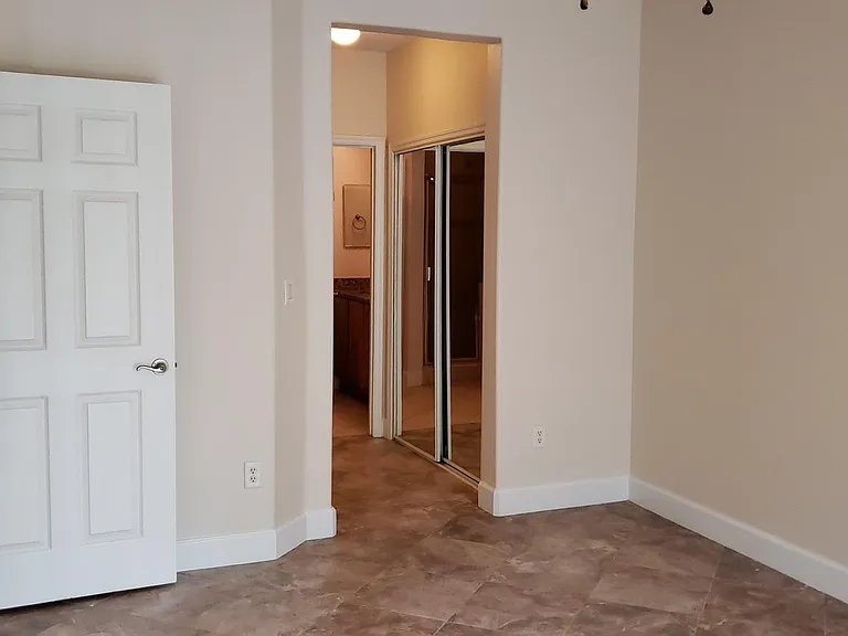 Master bedroom suite, corridor to the bathroom has closet with mirror doors