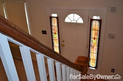 Stairway and foyer in living room : stain glass windows hardwood floor foyer new carpet in living ro