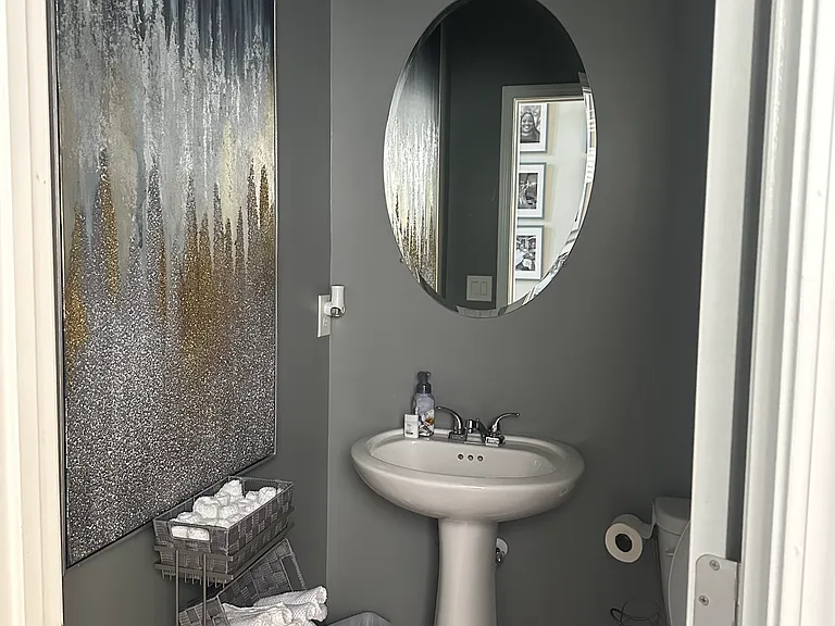 This well-appointed powder room adds both function and charm to the main level