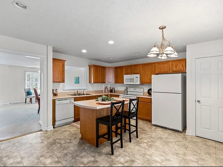 Kitchen with half bath and view into Living Room