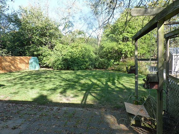 Large private backyard with patio. porch swing