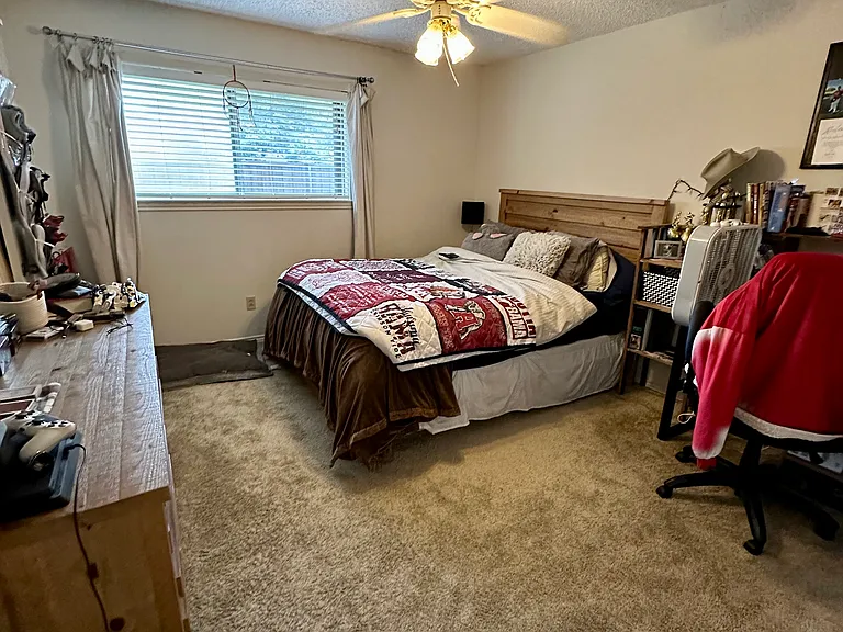Bedroom featuring a ceiling fan, carpet flooring